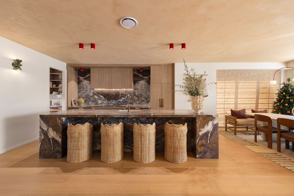 Modern kitchen with timber look kitchen cabinets and stone island bench with seating