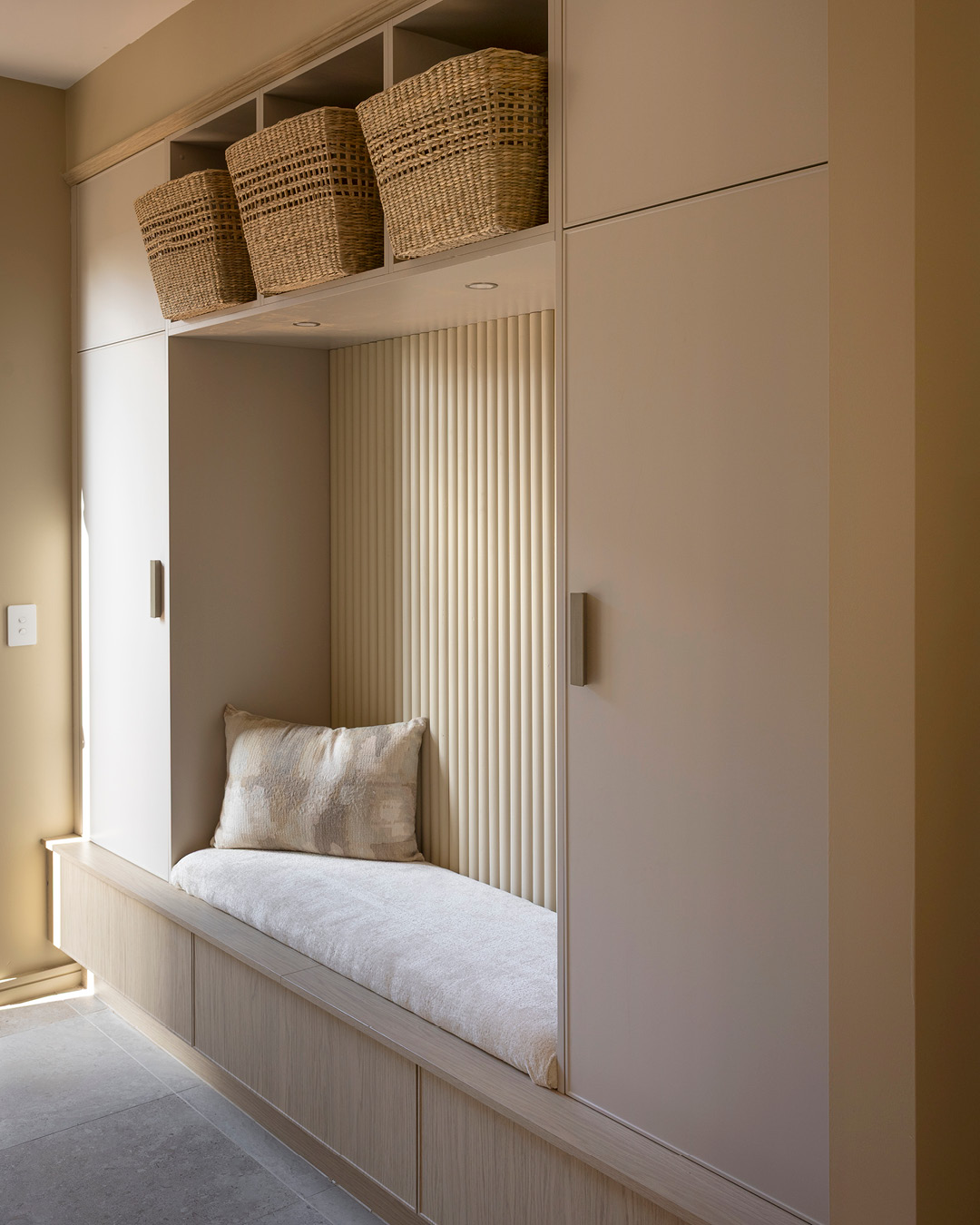 Mudroom with seating bench and storage cupboards and drawers