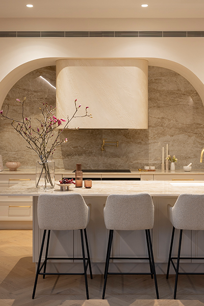 Statement kitchen with flowing curved design and warm lighting.
