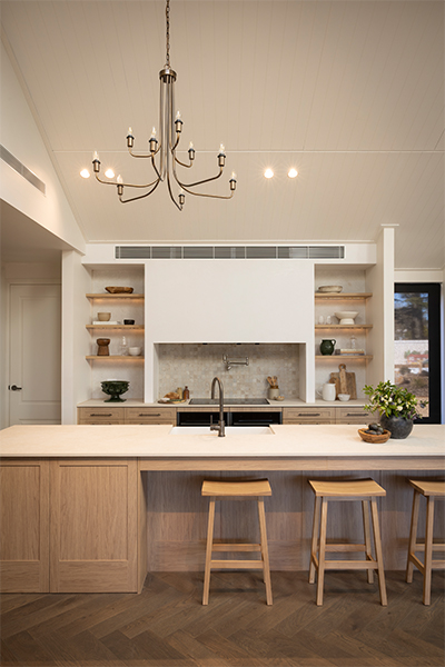 arge kitchen island featuring oak cabinetry, integrated storage, and seating for family gatherings.