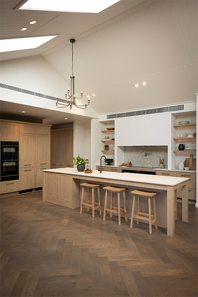 Spacious kitchen with an L-shaped layout, oak finishes, and refined modern farmhouse charm.