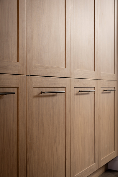 Country-style kitchen showcasing Shaker-style kitchen cabinets in Nordic Oak with bronze handles.